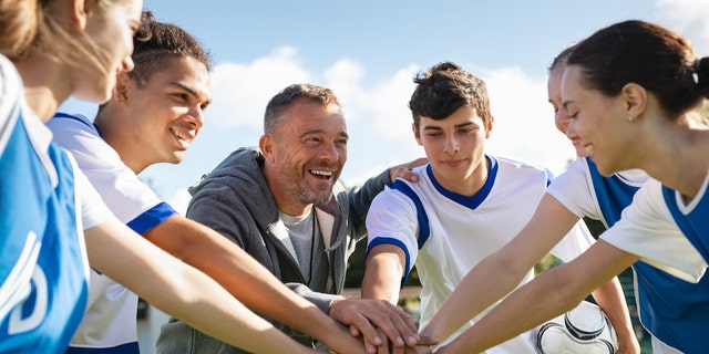 Coach with teen players