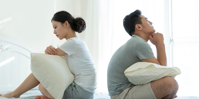 Couple sitting on bed