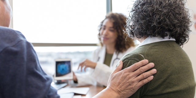 Older couple with doctor