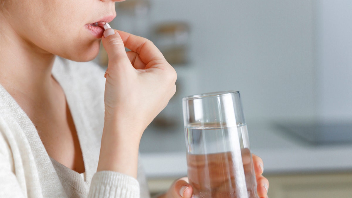 Woman taking pill