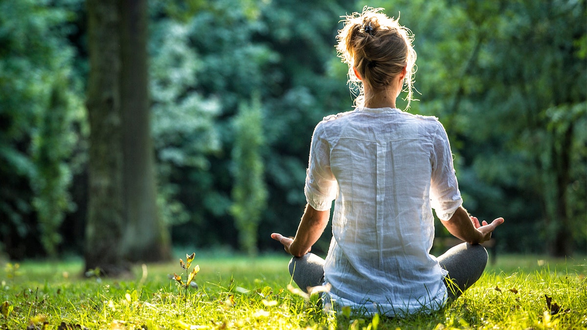 Woman meditating outside