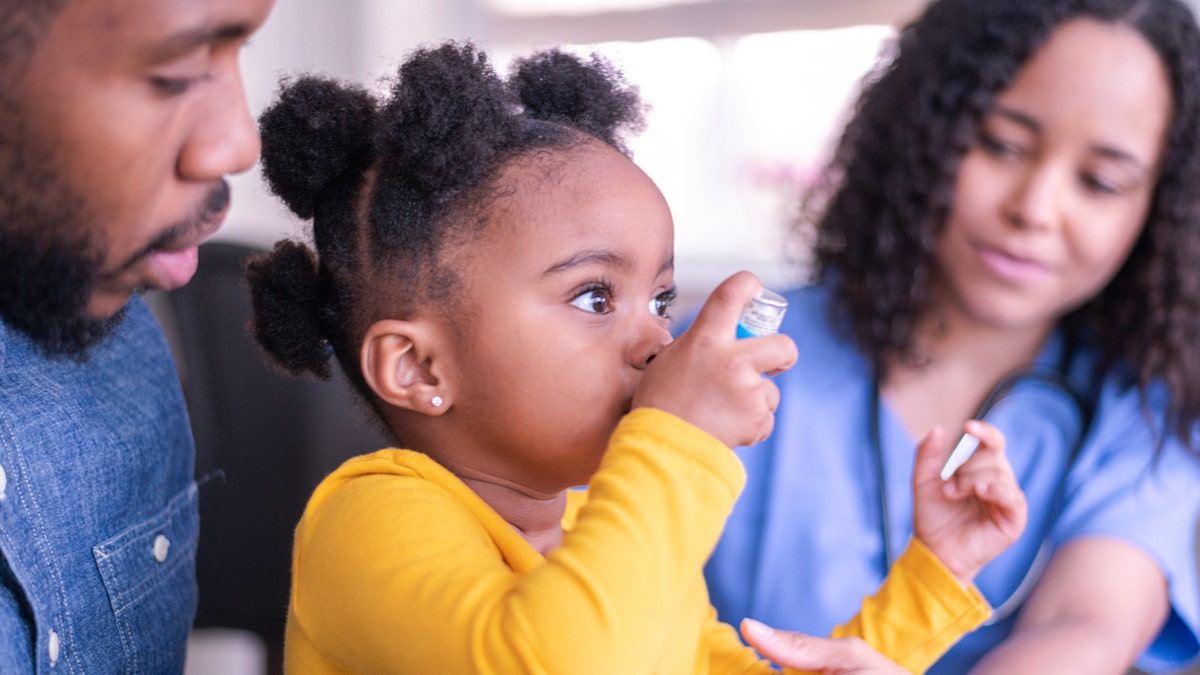 Young child using inhaler