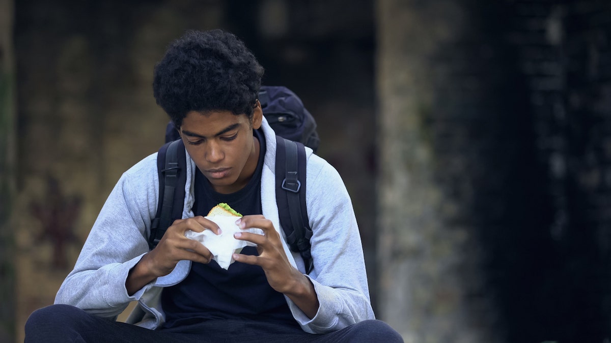 Teen boy eating