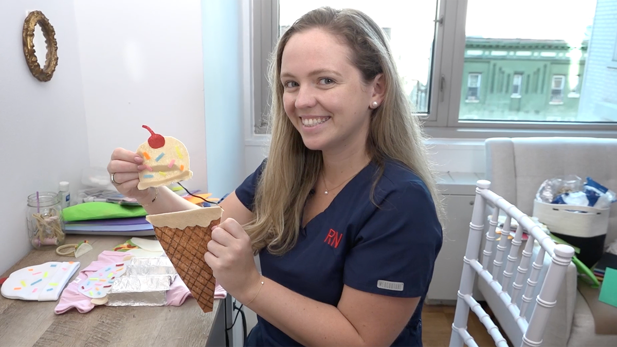 woman holding tiny Halloween costume