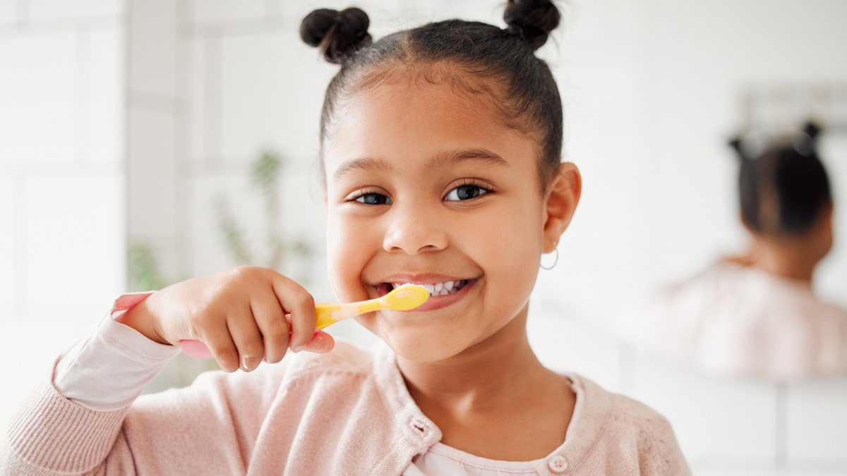 Kid brushing teeth