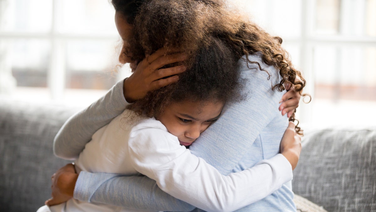 Mom hugging daughter