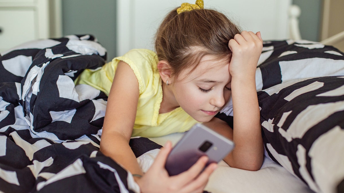 Girl in bed phone