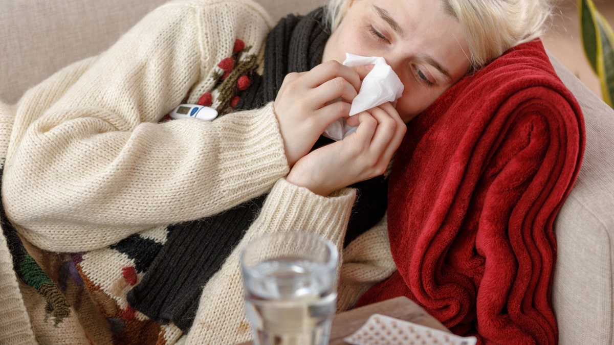 girl blowing nose