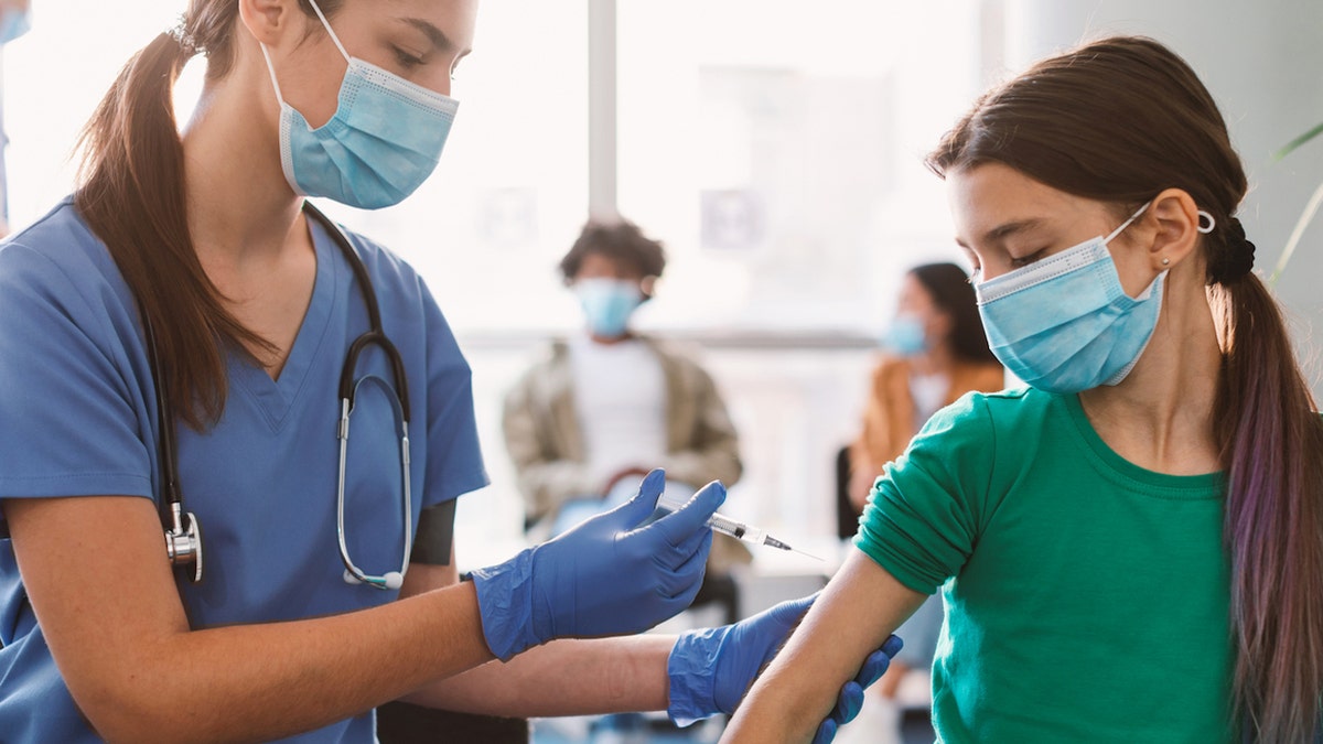 Teen getting vaccine