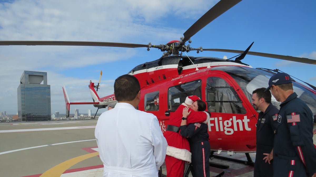 Santa hugging medical crew