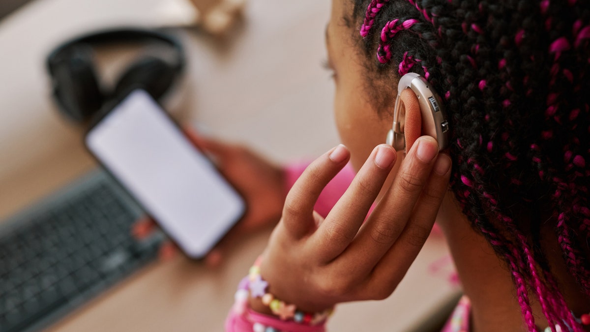 Girl with hearing aid