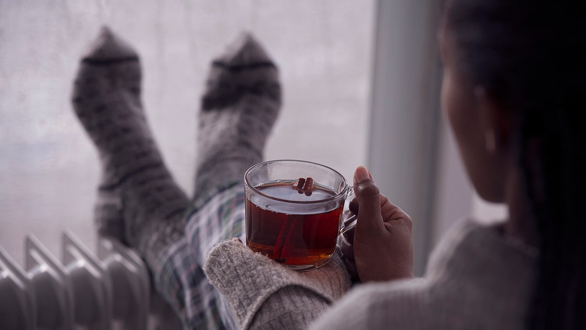 woman sips tea at home