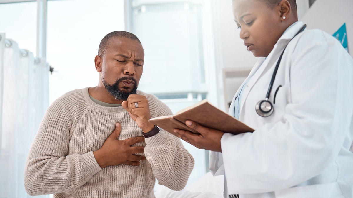 Man coughing at doctor