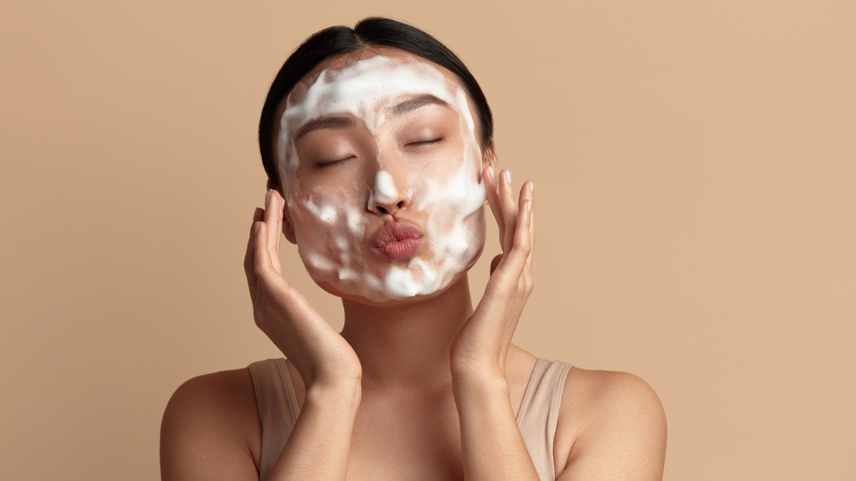 Woman washing her face