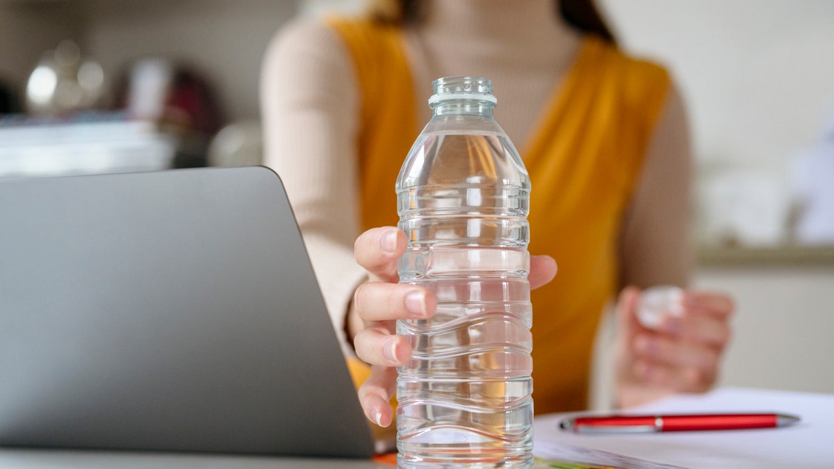 Reaching for water bottle