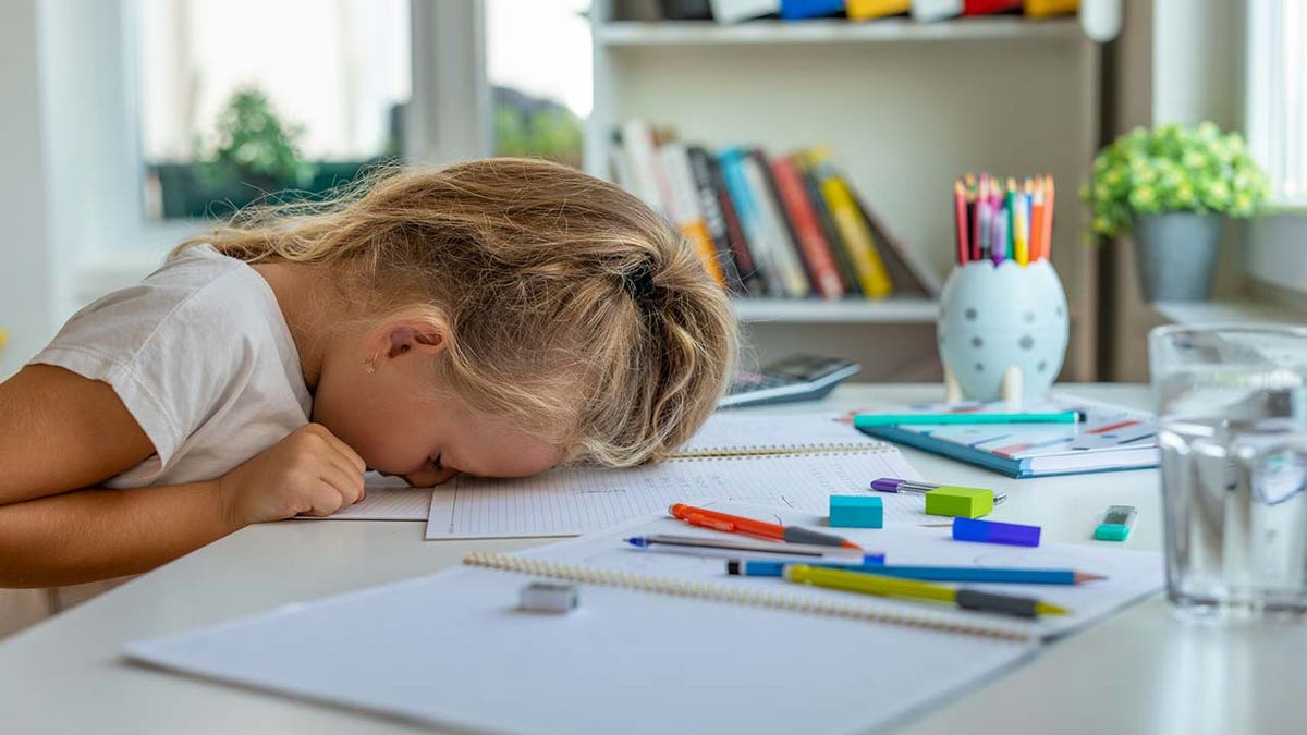 little girl tired from doing school work