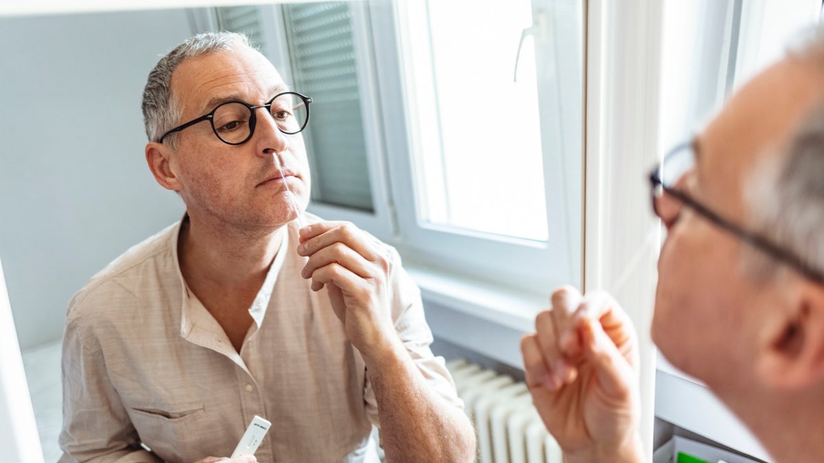 Man giving COVID test