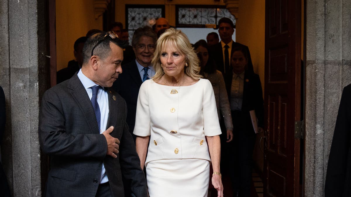 Anthony Bernal left, walking with first lady Jill Biden