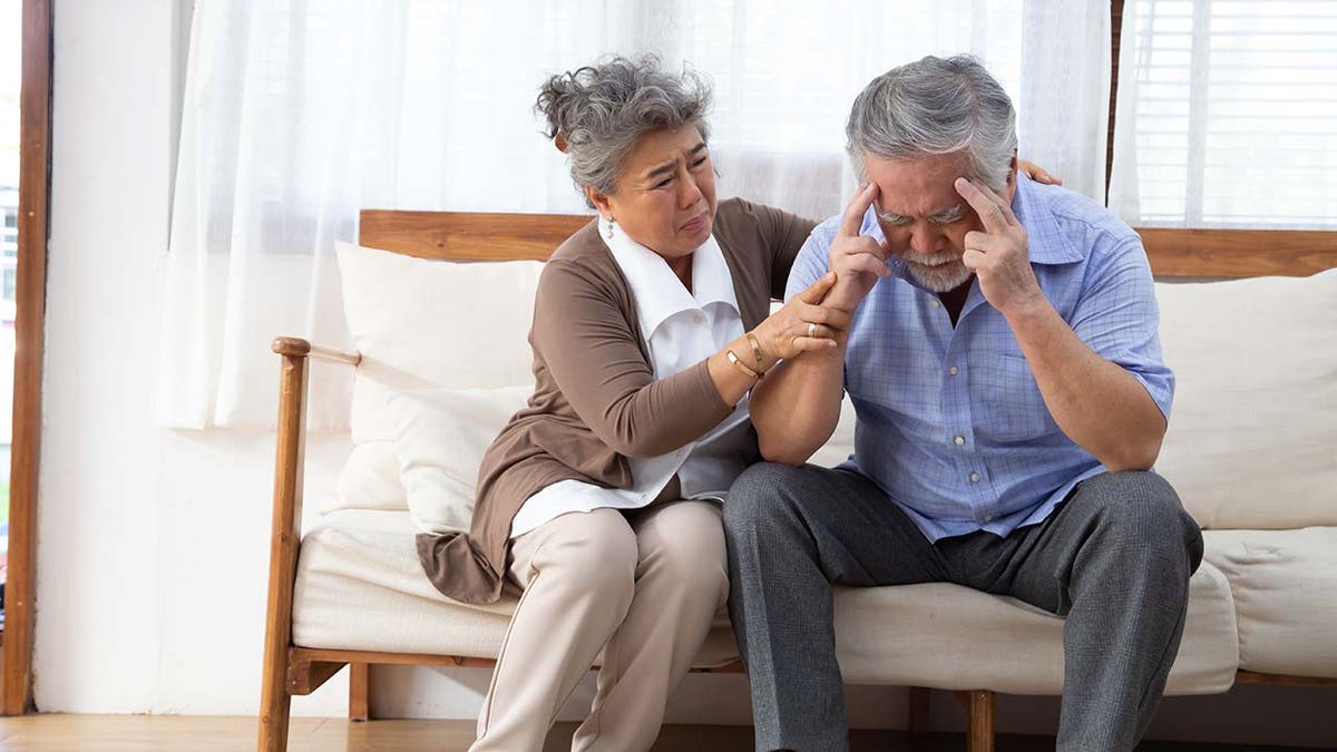 man with alzheimers supported by wife